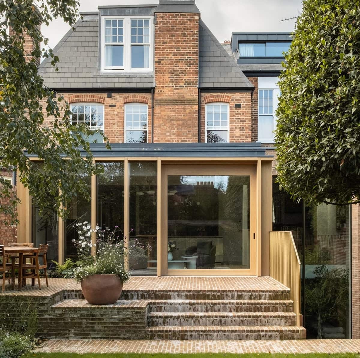 Modern timber sliding door opening the Garden Pavilion onto a landscaped terrace