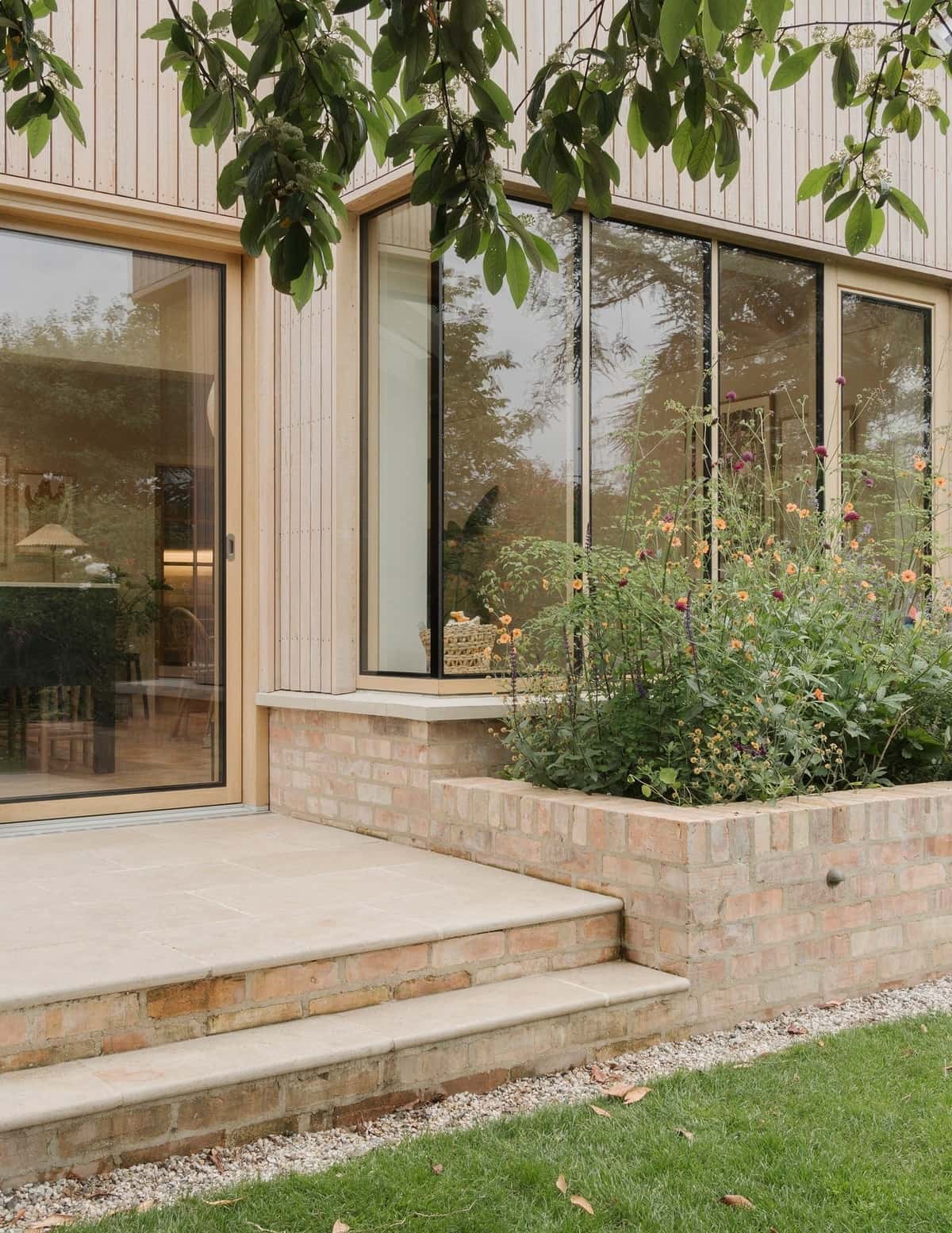 Modern timber windows and sliding door overlooking the Oaklight House garden