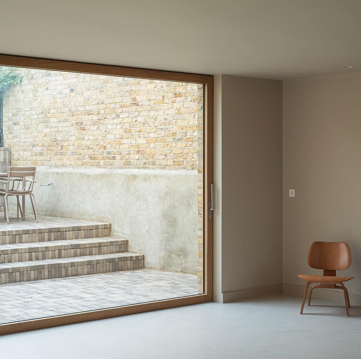 Modern timber sliding door framing the courtyard at Still Frame