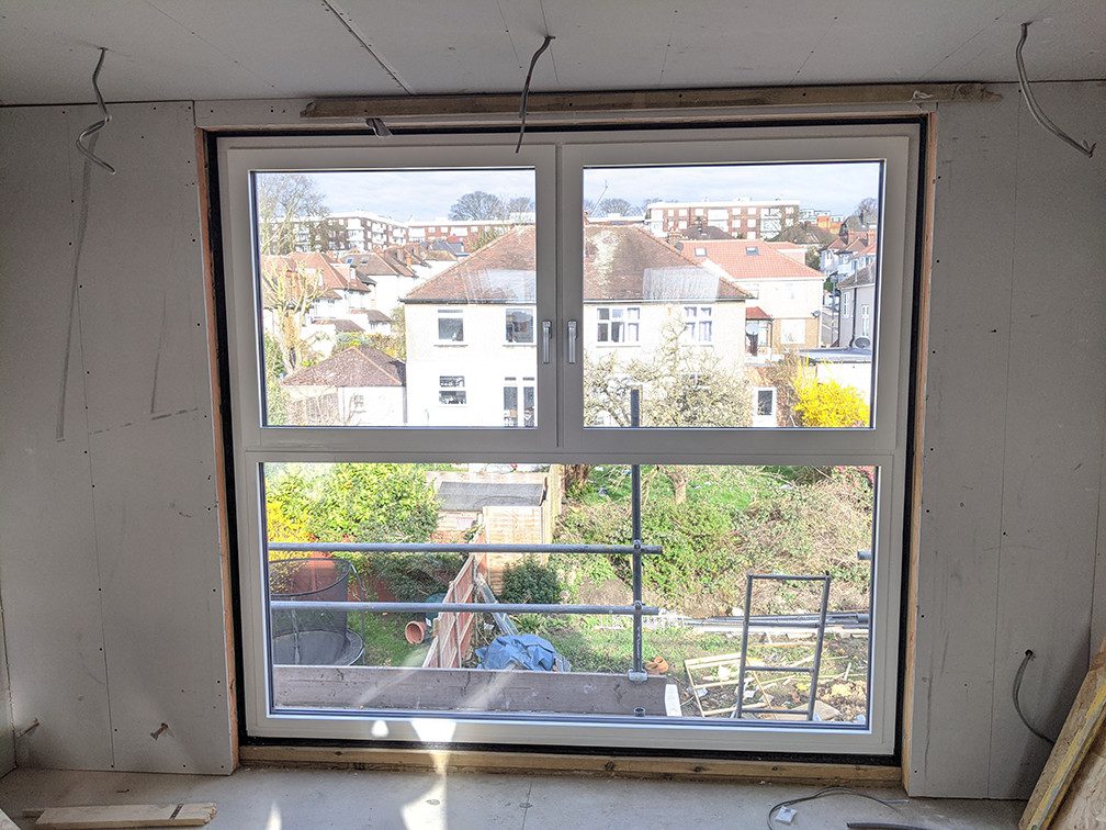 Plasterboard prepared to have wet plaster applied after the window has been installed without adequate provision for dehumidification