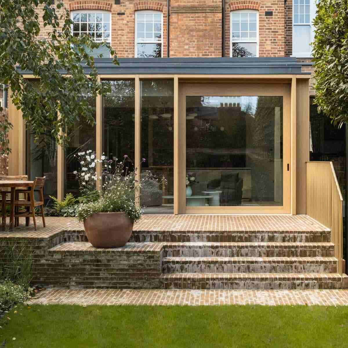 An outside view on the vantage modern oak sliding door used for Garden Pavilion project