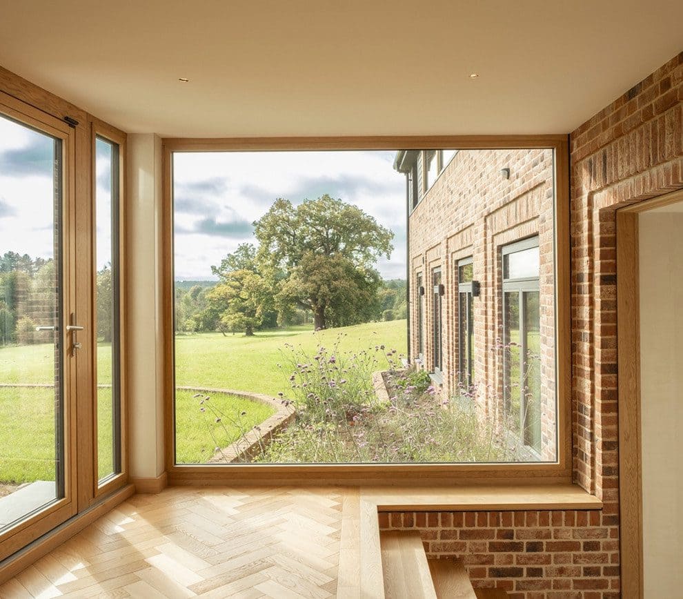 Dark aluminium-clad windows with timber interior